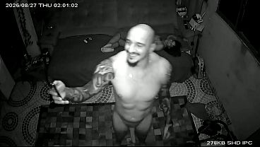 The lover sends a kiss to the cuckold through the security camera after with his wife.